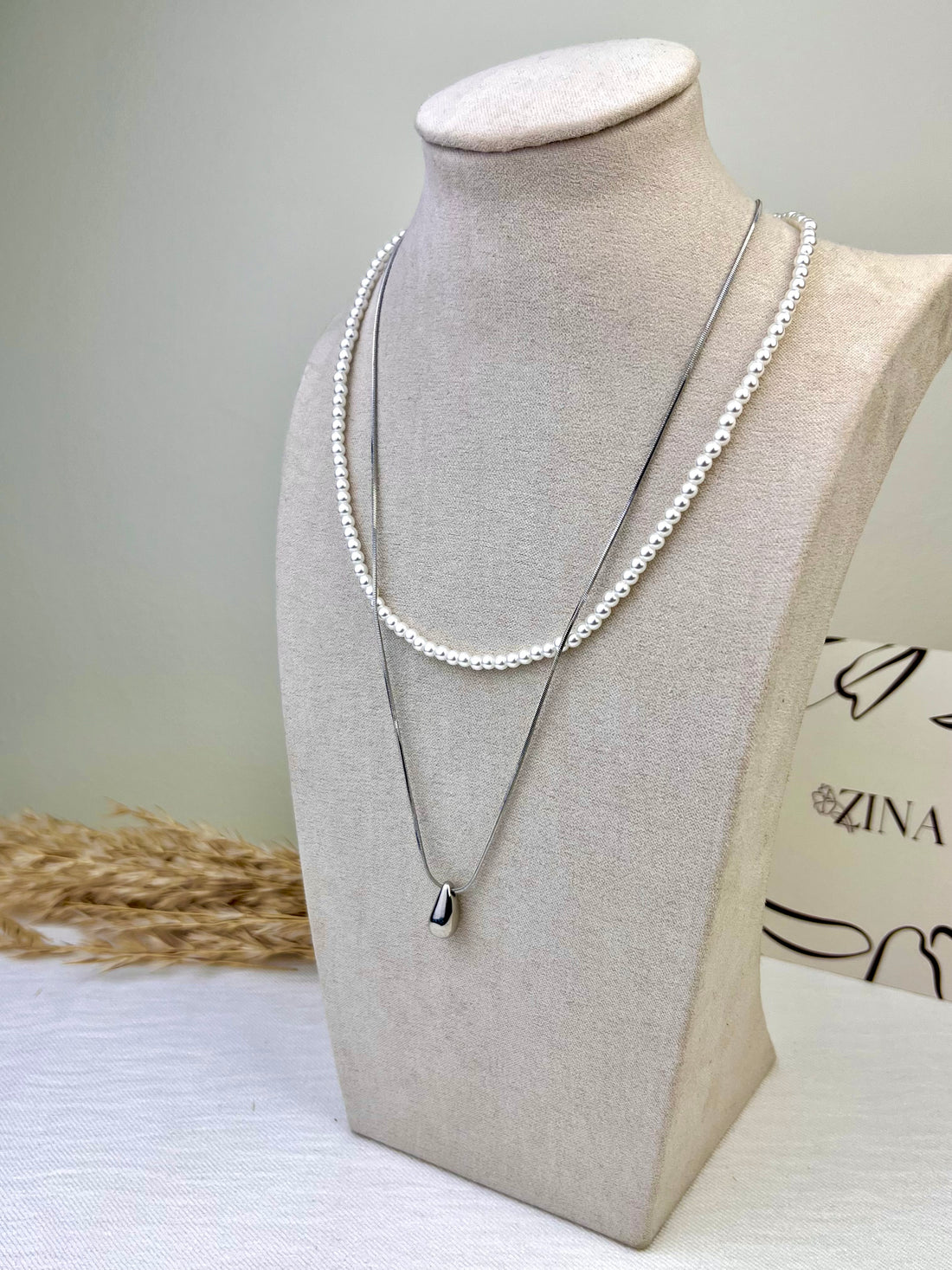 Two-strand silver necklace with white beads