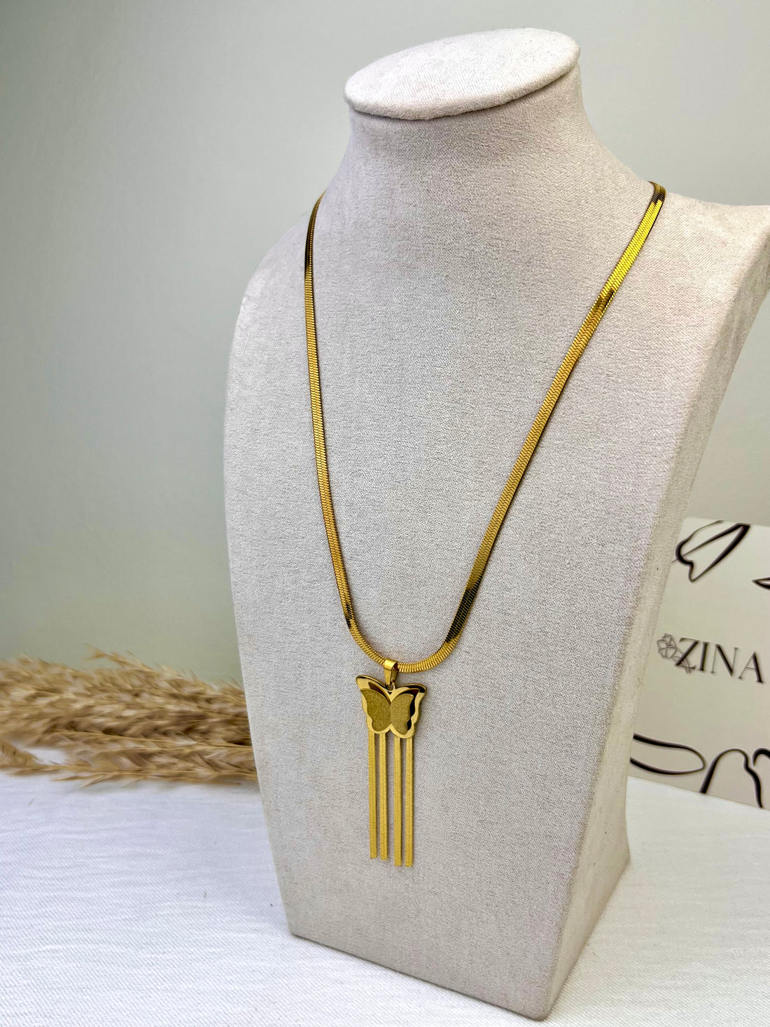 Cobra chain with butterfly and metal tassels