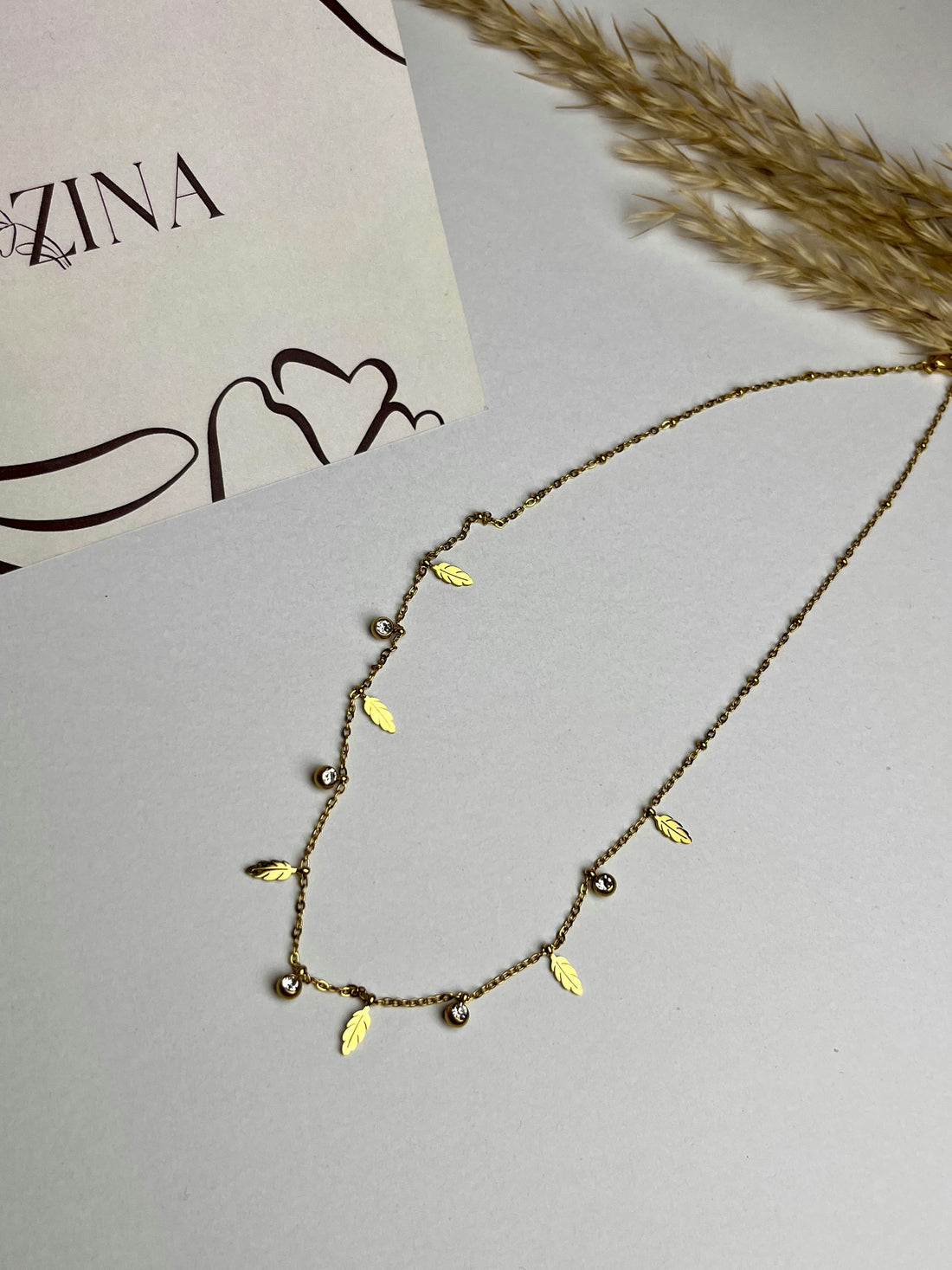 A series of golden balls with leaves and beads