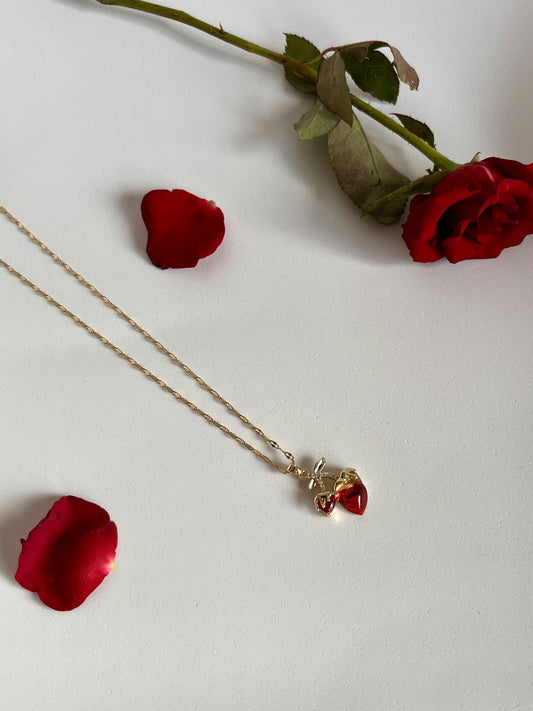 Red heart pendant with a raised charm