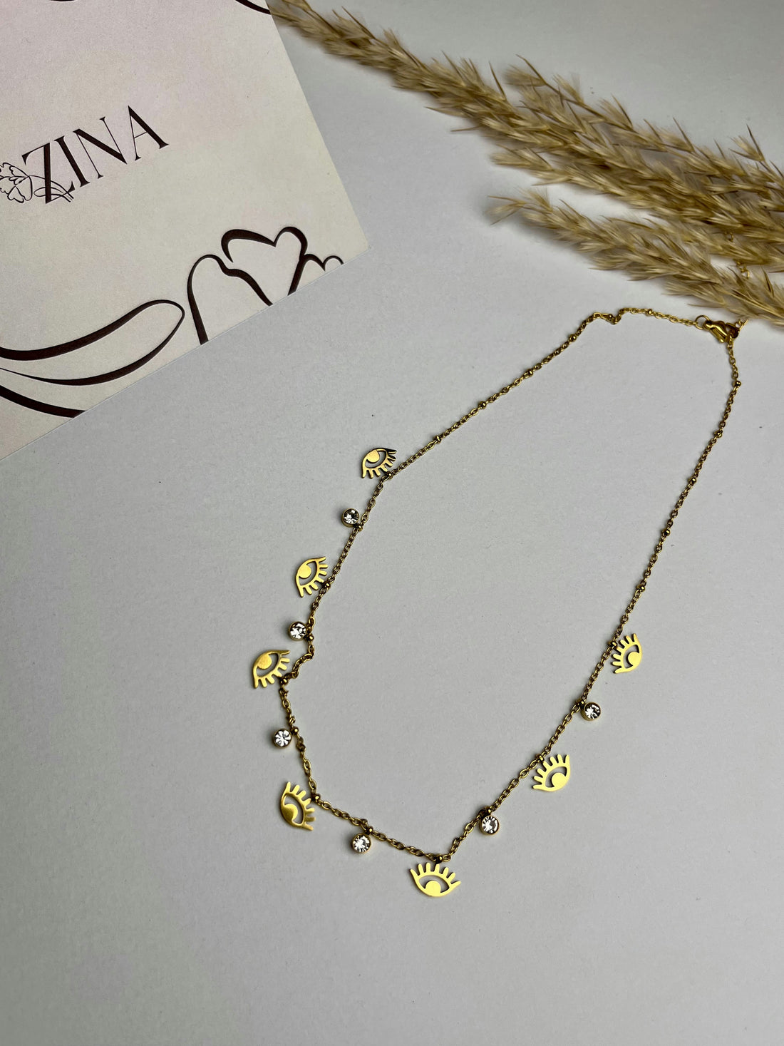 A chain of gold balls with eyes and rhinestones