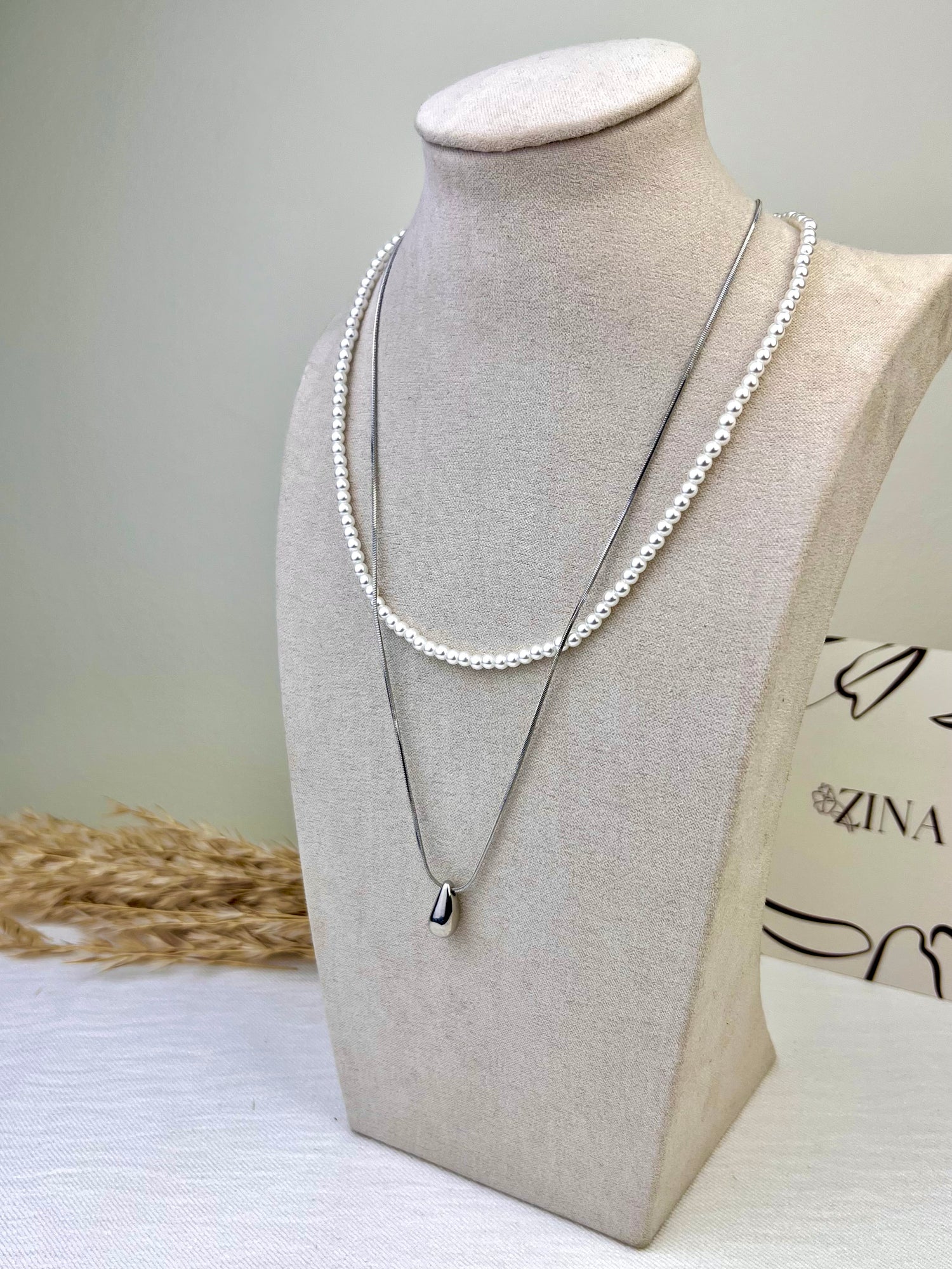 Two-strand silver necklace with white beads